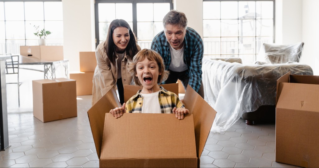 family plays while packing boxes getting ready to move during seller possession or buyer possession in Lake Norman 