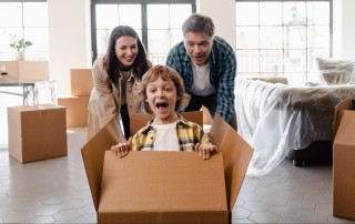 family plays while packing boxes getting ready to move during seller possession